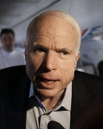 Republican presidential hopeful, Sen. John McCain, R-Ariz., talks with reporters on his charter plane as he travels from Phoenix to Washington, Wednesday, Feb. 6, 2008, the day after the Super Tuesday primary elections. (AP Photo/Charles Dharapak)